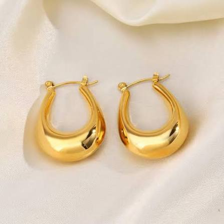 Gold earrings on satin